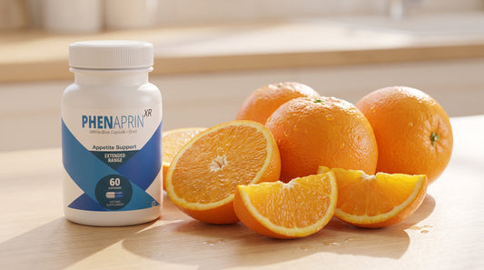 Fresh bitter orange fruit and slices beside a PhenAprin XR bottle on a clean light surface, natural and appetizing, premium.